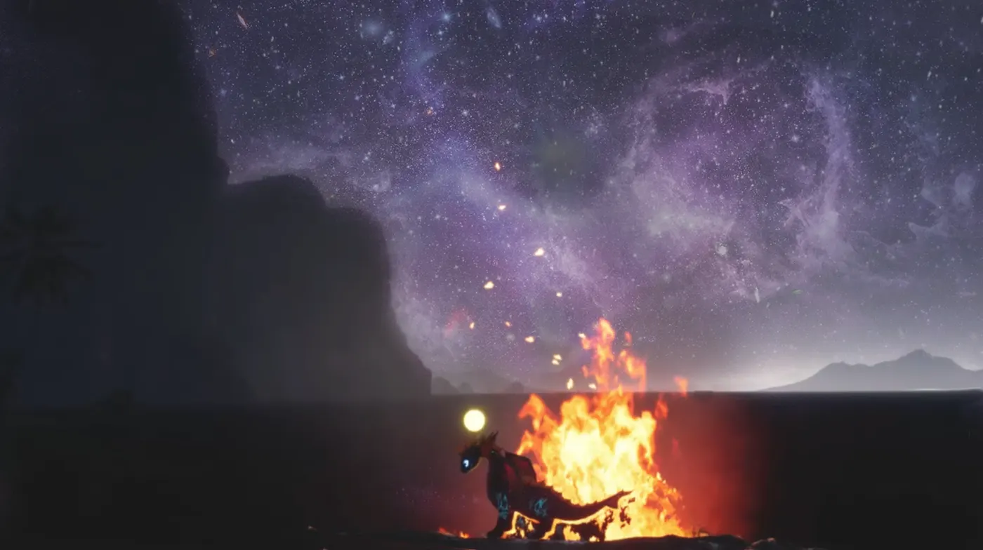 A fire burning at night beneath dark cliffs